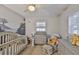 Serene Bedroom featuring crib, dresser, and a tranquil atmosphere with charming decor at 4489 57Th N Ave, St Petersburg, FL 33714