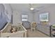 Charming Bedroom with a crib, a dresser, and soothing gray tones, perfect for a little one at 4489 57Th N Ave, St Petersburg, FL 33714