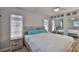 Comfortable bedroom with wood-look bedframe, modern decor, and mirrored closet doors at 4489 57Th N Ave, St Petersburg, FL 33714