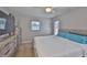 Inviting bedroom featuring natural light, wood-look furnishings, and an airy ambiance at 4489 57Th N Ave, St Petersburg, FL 33714