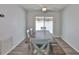 Well-lit dining area featuring modern wood-look flooring, ceiling fan, and access to outdoor space at 4489 57Th N Ave, St Petersburg, FL 33714
