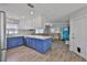 Open layout kitchen with blue cabinets, stainless steel appliances, and updated backsplash at 4489 57Th N Ave, St Petersburg, FL 33714