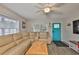 Bright living room featuring a tan sectional sofa, ceiling fan, and wood-look flooring at 4489 57Th N Ave, St Petersburg, FL 33714