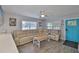 Bright living room featuring a tan sectional sofa, ceiling fan, and wood-look flooring at 4489 57Th N Ave, St Petersburg, FL 33714
