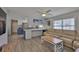 Open-concept living area with a large tan couch, ceiling fan, and wood-look floors at 4489 57Th N Ave, St Petersburg, FL 33714