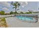 Backyard with a kidney-shaped pool, patio, and safety fence, surrounded by lush landscaping at 4489 57Th N Ave, St Petersburg, FL 33714