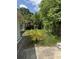 Exterior image of the backyard with grass and a small tree next to the house at 467 34Th N Ave, St Petersburg, FL 33704