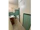 A bathroom features green and white tiles, a sink, toilet, and a bathtub with a shower curtain rod at 467 34Th N Ave, St Petersburg, FL 33704