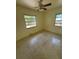 A bedroom with two windows and ceiling fan offers natural light and classic terrazzo flooring at 467 34Th N Ave, St Petersburg, FL 33704