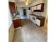 Traditional kitchen with white appliances, wood cabinets, and terrazzo flooring at 467 34Th N Ave, St Petersburg, FL 33704