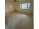 Sunny living room boasting terrazzo flooring, neutral walls and a ceiling fan at 467 34Th N Ave, St Petersburg, FL 33704