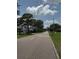 Street view with the road curving to the left, with lush trees visible to each side at 467 34Th N Ave, St Petersburg, FL 33704