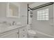 Bright bathroom with white vanity, marble countertops, tub and shower with glass block window at 5262 25Th N Ave, St Petersburg, FL 33710