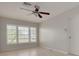 Neutral bedroom featuring tile flooring, a ceiling fan, and window with white shutters at 5262 25Th N Ave, St Petersburg, FL 33710