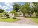 Attractive single-story home with a brick driveway, well-kept lawn, and mature landscaping at 5262 25Th N Ave, St Petersburg, FL 33710