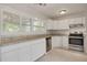Bright kitchen features tile flooring, stainless steel appliances and granite countertops at 5262 25Th N Ave, St Petersburg, FL 33710
