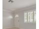 Clean living room featuring a front door, shuttered windows, and tile floors at 5262 25Th N Ave, St Petersburg, FL 33710