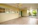 View of covered patio featuring wood-look tile, ceiling fans, and access to the lush outdoor area at 5262 25Th N Ave, St Petersburg, FL 33710