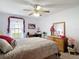 Comfortable bedroom featuring a ceiling fan, window, desk, and natural lighting at 5755 Yorkshire Dr, Zephyrhills, FL 33542