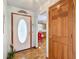 Inviting foyer with wood flooring, and views to an adjacent Kitchen at 5755 Yorkshire Dr, Zephyrhills, FL 33542