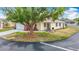Charming single-story home showcasing a brick facade, manicured landscaping, and a two-car garage at 5755 Yorkshire Dr, Zephyrhills, FL 33542