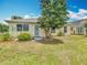 Well-kept single-story home featuring attractive landscaping, white trim, and inviting curb appeal at 5755 Yorkshire Dr, Zephyrhills, FL 33542