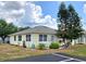 Charming single-story home with well-kept lawn, garden features, and inviting front entrance at 5755 Yorkshire Dr, Zephyrhills, FL 33542