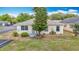 Inviting single-story home with neat front yard, garden details, and serene neighborhood setting at 5755 Yorkshire Dr, Zephyrhills, FL 33542