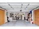 Spacious garage with ample storage and workspace featuring dual ceiling fans at 5755 Yorkshire Dr, Zephyrhills, FL 33542