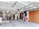 Well-organized garage space providing ample storage and workspace with great lighting at 5755 Yorkshire Dr, Zephyrhills, FL 33542