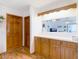 Traditional kitchen features wooden cabinets, hardwood floors and a bar counter at 5755 Yorkshire Dr, Zephyrhills, FL 33542