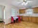 Bright kitchen with hardwood floors, breakfast table, and wooden cabinets at 5755 Yorkshire Dr, Zephyrhills, FL 33542