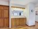 Traditional kitchen with wooden cabinets, bar counter, and hardwood floors at 5755 Yorkshire Dr, Zephyrhills, FL 33542