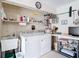 Functional laundry room featuring a washer, dryer, utility sink, and shelving at 5755 Yorkshire Dr, Zephyrhills, FL 33542