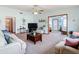 Inviting living room with neutral furniture, a ceiling fan, and plenty of space to relax at 5755 Yorkshire Dr, Zephyrhills, FL 33542
