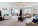 Bright living room featuring neutral furniture, a ceiling fan, and plenty of natural light at 5755 Yorkshire Dr, Zephyrhills, FL 33542