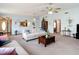 Comfortable living room featuring neutral furniture, ceiling fans, and an open floor plan at 5755 Yorkshire Dr, Zephyrhills, FL 33542