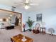 Open living room with light blue walls, ceiling fan, and seamless access to other rooms at 5755 Yorkshire Dr, Zephyrhills, FL 33542