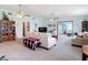 Large living room with carpeted floor and ample sunlight at 5755 Yorkshire Dr, Zephyrhills, FL 33542