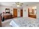 Well-lit main bedroom with an ensuite bathroom and dark wood furniture at 5755 Yorkshire Dr, Zephyrhills, FL 33542