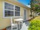 Cozy outdoor seating area with a charming white table and chairs near lush landscaping at 5755 Yorkshire Dr, Zephyrhills, FL 33542