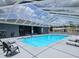 A sparkling, screened-in community pool with ample seating for residents at 5755 Yorkshire Dr, Zephyrhills, FL 33542