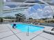 Bright, screened-in pool and lounging area in a sunny community setting at 5755 Yorkshire Dr, Zephyrhills, FL 33542