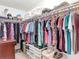 Spacious walk-in closet with ample storage and clothing racks at 5755 Yorkshire Dr, Zephyrhills, FL 33542