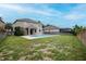 Spacious backyard with a covered patio, an inground swimming pool, green grass and wood fence at 5916 Tulip Flower Dr, Riverview, FL 33578
