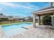 Inviting backyard with a pool, patio area, and well-manicured lawn at 5916 Tulip Flower Dr, Riverview, FL 33578