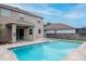 Beautiful backyard with a refreshing swimming pool and a tiled patio area at 5916 Tulip Flower Dr, Riverview, FL 33578