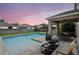 Inviting backyard features a pool, patio with seating, dining area, and lush landscaping, perfect for outdoor living and entertaining at 5916 Tulip Flower Dr, Riverview, FL 33578