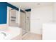 Bathroom with tiled floors, glass shower, vanity and white walls at 5916 Tulip Flower Dr, Riverview, FL 33578