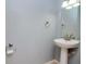 Powder room features pedestal sink and neutral paint at 5916 Tulip Flower Dr, Riverview, FL 33578